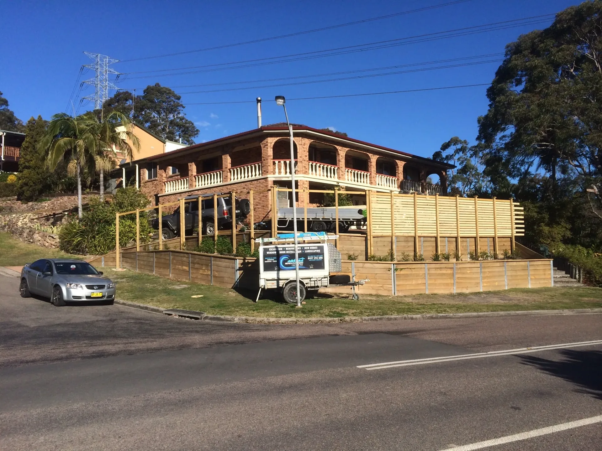Tiered timber retaining walls on a hillside home frontage