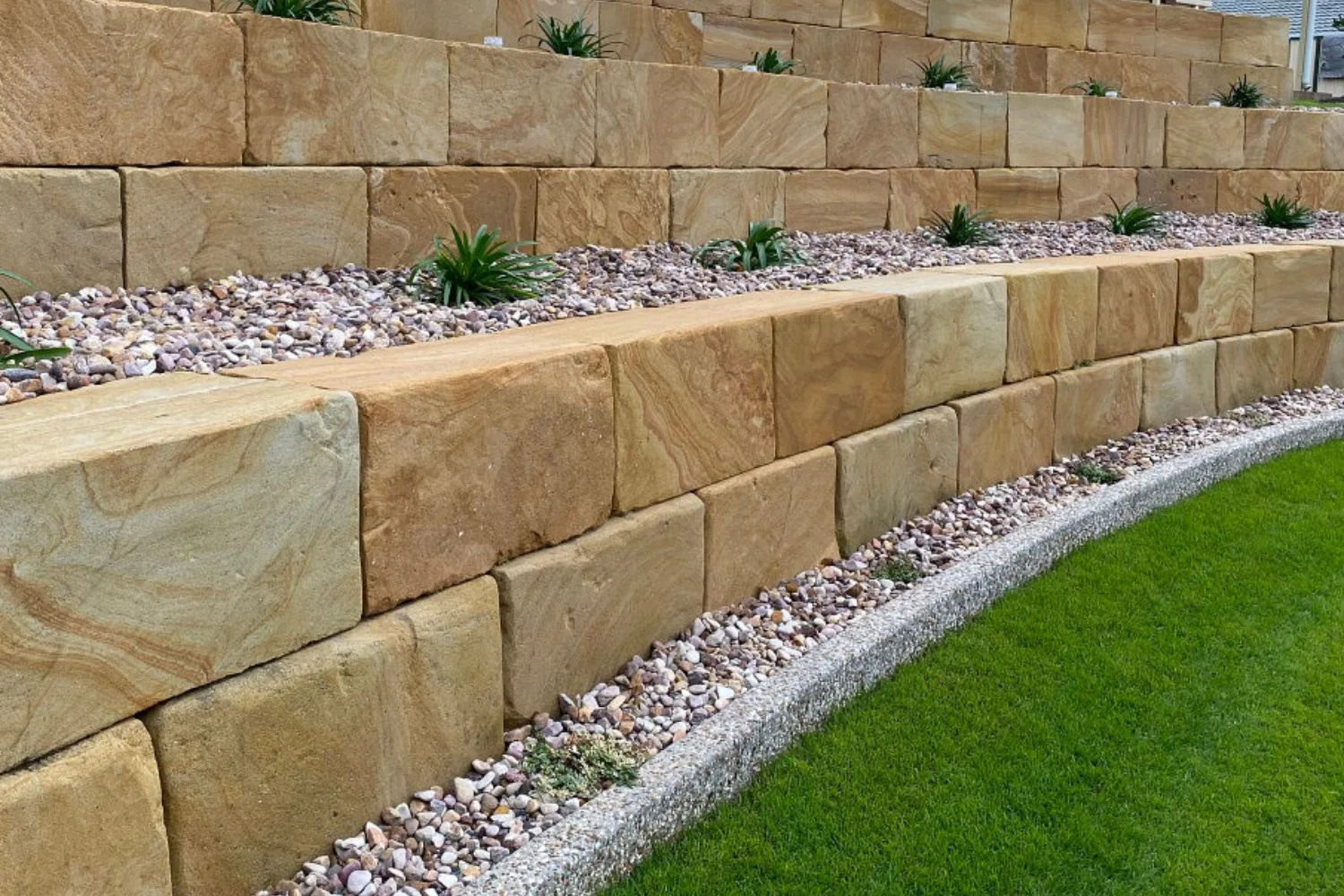 Two-tier sandstone block retaining walls with gravel beds